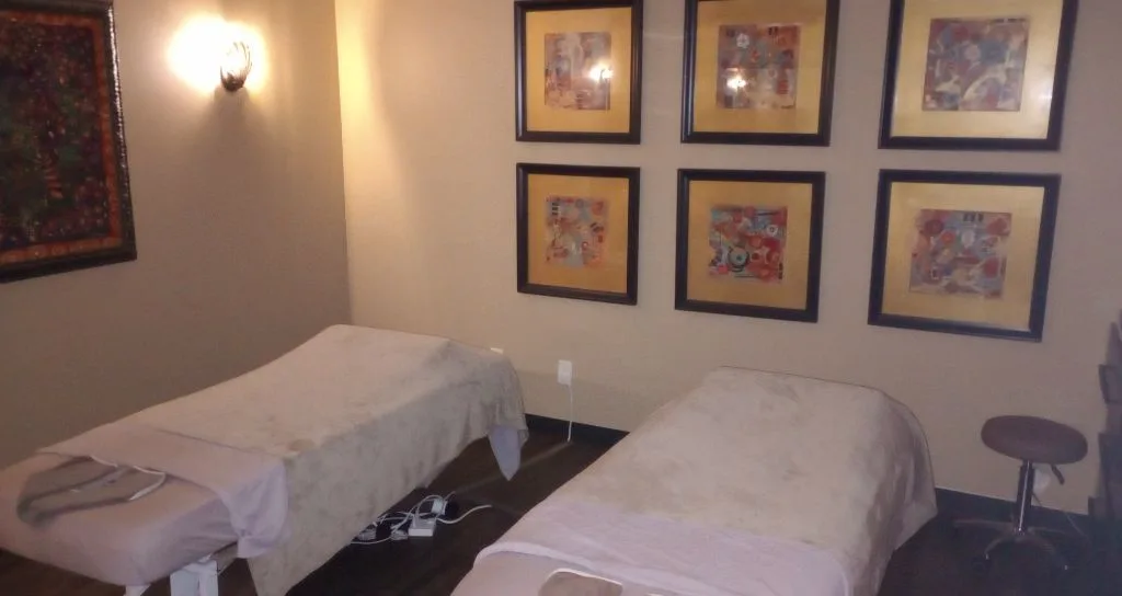 Healing Hands Massage & Spa interior — the couples suite in Clearwater, FL with side-by-side massage tables and warm lighting